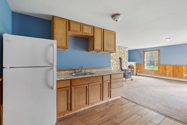 20 Motorcycle Dr, Windham, ME 04062 - kitchen with freestanding refrigerator, a sink, baseboard heating, light countertops, and a wainscoted wall