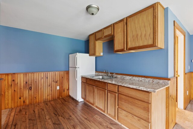 20 Motorcycle Dr, Windham, ME 04062 - kitchen featuring a sink, a wainscoted wall, wood-type flooring, freestanding refrigerator, and wooden walls