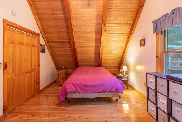 32 Sandy Beach Rd, Danforth, ME 04424 - bedroom with wooden ceiling, light wood-style flooring, and baseboards