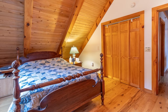 32 Sandy Beach Rd, Danforth, ME 04424 - bedroom with lofted ceiling, light wood finished floors, wooden ceiling, and baseboards
