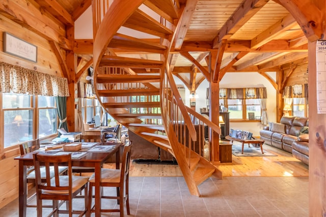 32 Sandy Beach Rd, Danforth, ME 04424 - tiled dining space featuring stairway, wooden ceiling with exposed beams, and wooden walls