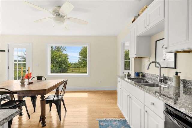276 N Sedgwick Rd, Sedgwick, ME 04676 - kitchen featuring a sink, light wood-style flooring, dishwasher, light stone countertops, and baseboards
