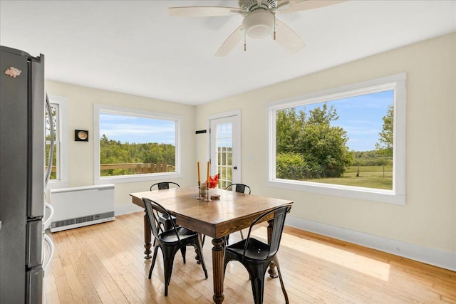 276 N Sedgwick Rd, Sedgwick, ME 04676 - dining space with light wood-type flooring, radiator heating unit, a ceiling fan, and baseboards