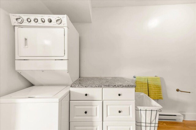 276 N Sedgwick Rd, Sedgwick, ME 04676 - laundry area with stacked washer / drying machine, baseboard heating, and light wood-style floors