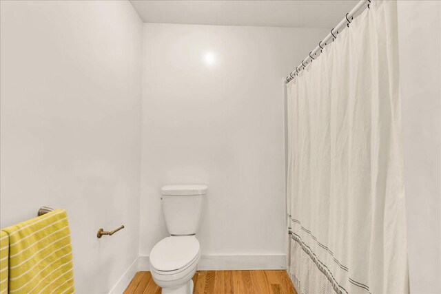 276 N Sedgwick Rd, Sedgwick, ME 04676 - full bathroom with toilet, wood finished floors, baseboards, and a shower with shower curtain