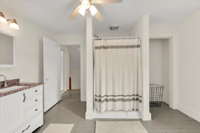 276 N Sedgwick Rd, Sedgwick, ME 04676 - bathroom featuring vanity, hardwood / wood-style flooring, a ceiling fan, and curtained shower