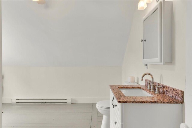 276 N Sedgwick Rd, Sedgwick, ME 04676 - half bath featuring toilet, baseboard heating, vanity, and lofted ceiling
