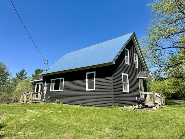 338 River Rd, Bucksport, ME 04416 - view of side of home with a yard and metal roof