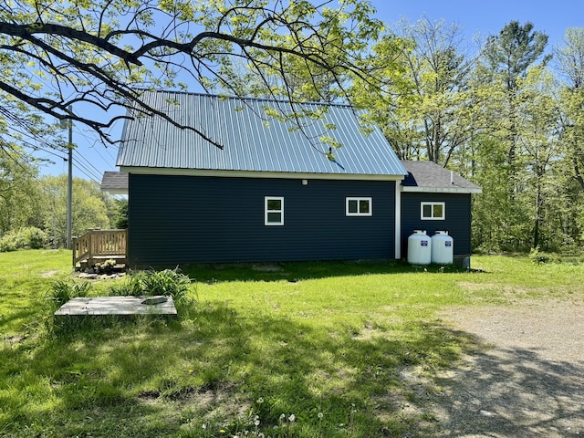 338 River Rd, Bucksport, ME 04416 - view of side of property featuring a yard, a deck, and metal roof