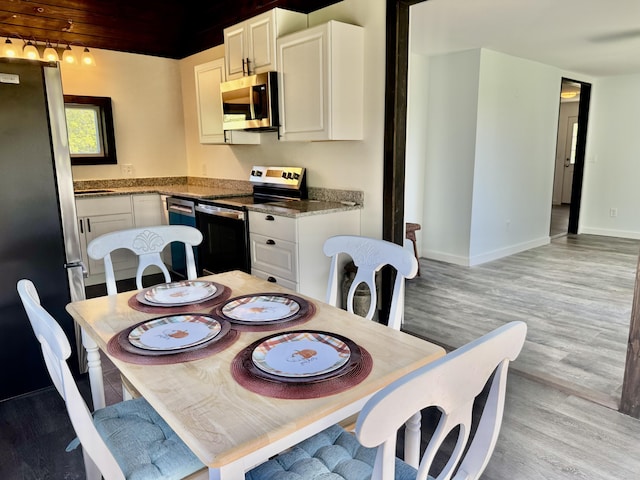 338 River Rd, Bucksport, ME 04416 - dining area featuring light wood-type flooring and baseboards