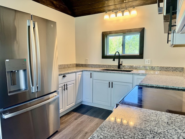 338 River Rd, Bucksport, ME 04416 - kitchen with stainless steel fridge with ice dispenser, a sink, dark wood-style flooring, white cabinetry, and wood ceiling