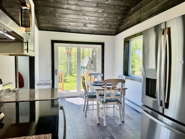 338 River Rd, Bucksport, ME 04416 - dining area featuring lofted ceiling, wood ceiling, dark wood-style flooring, and baseboard heating