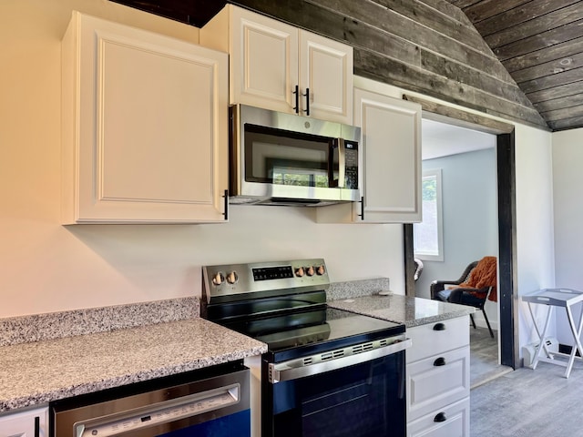 338 River Rd, Bucksport, ME 04416 - kitchen with appliances with stainless steel finishes, wood ceiling, light wood finished floors, white cabinets, and lofted ceiling