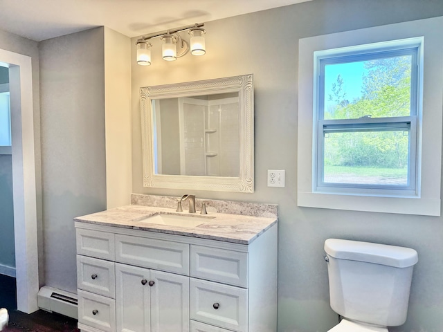338 River Rd, Bucksport, ME 04416 - full bathroom featuring a baseboard radiator, plenty of natural light, vanity, and toilet