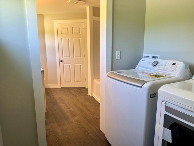 338 River Rd, Bucksport, ME 04416 - laundry area with washing machine and clothes dryer and dark wood-type flooring