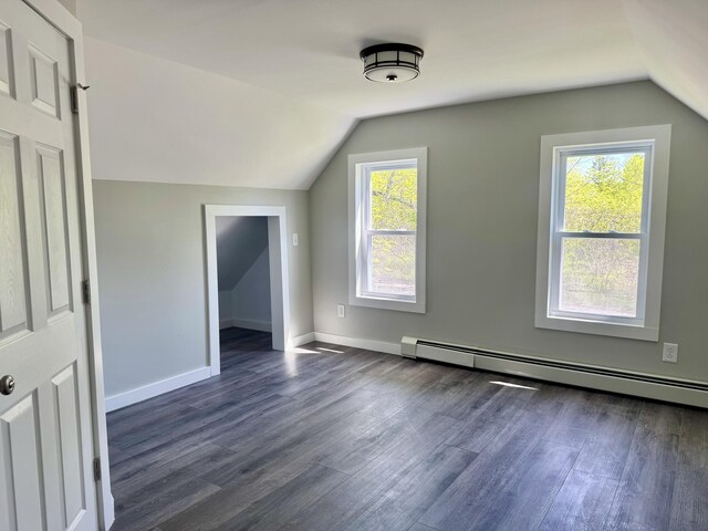 338 River Rd, Bucksport, ME 04416 - additional living space featuring lofted ceiling, a baseboard radiator, dark wood-style flooring, healthy amount of natural light, and baseboards