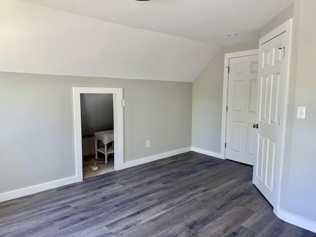 338 River Rd, Bucksport, ME 04416 - bonus room featuring lofted ceiling, dark wood-style floors, and baseboards