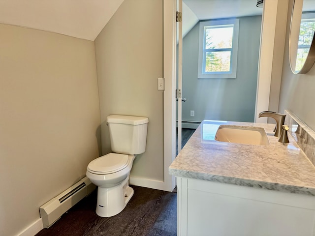 338 River Rd, Bucksport, ME 04416 - bathroom featuring baseboard heating, vanity, toilet, lofted ceiling, and baseboards