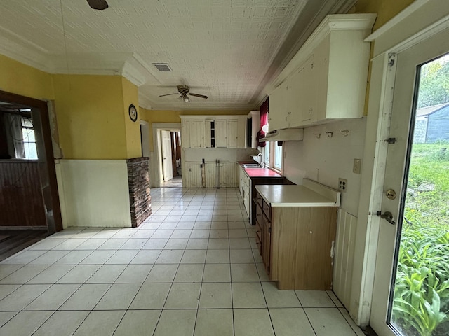529 Main St, East Machias, ME 04630 - kitchen featuring ceiling fan, a sink, light tile patterned floors, light countertops, and ornamental molding