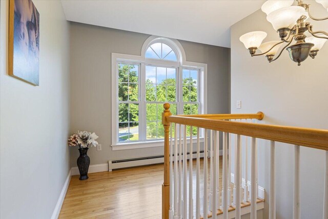 3 Highpointe Cir, Kittery, ME 03904 - hallway with a chandelier, a baseboard heating unit, light wood-type flooring, and plenty of natural light