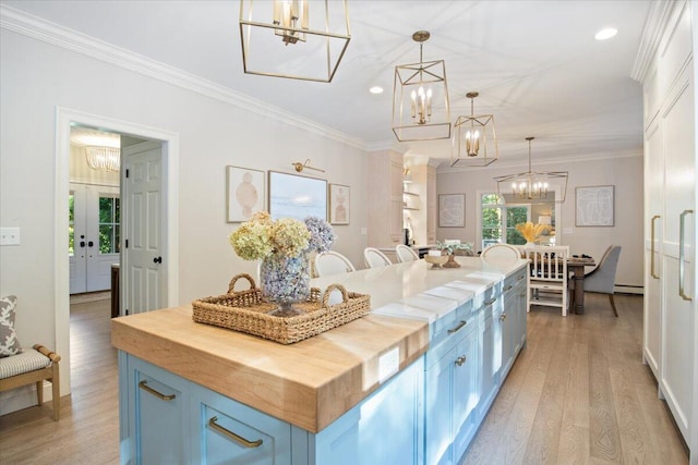 3 Highpointe Cir, Kittery, ME 03904 - kitchen featuring butcher block countertops, a chandelier, blue cabinets, light wood-style flooring, and crown molding