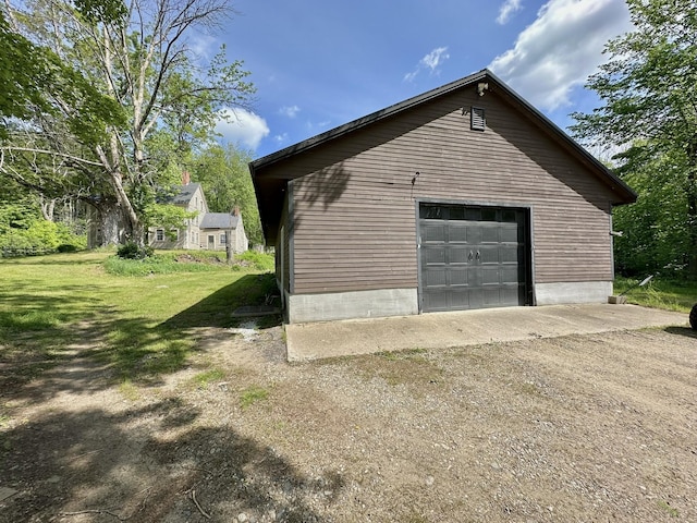 13 Mountain Rd, Newfield, ME 04095 - view of property exterior featuring dirt driveway, a detached garage, a yard, and an outbuilding