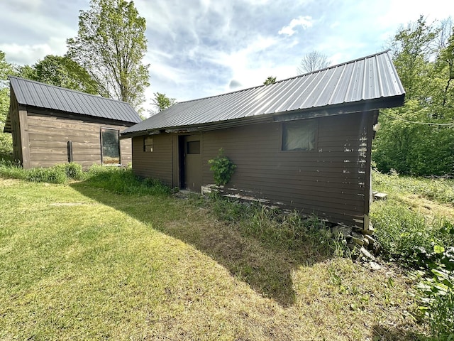 13 Mountain Rd, Newfield, ME 04095 - rear view of property with a lawn, metal roof, and an outdoor structure