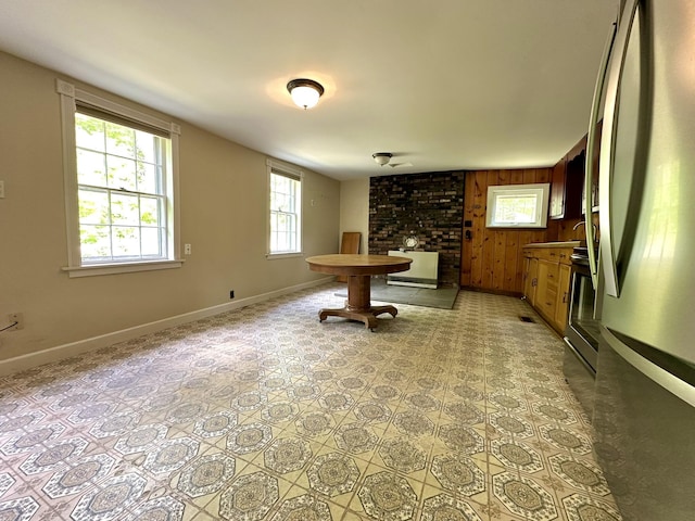 13 Mountain Rd, Newfield, ME 04095 - dining room with baseboards, a fireplace, and wood walls