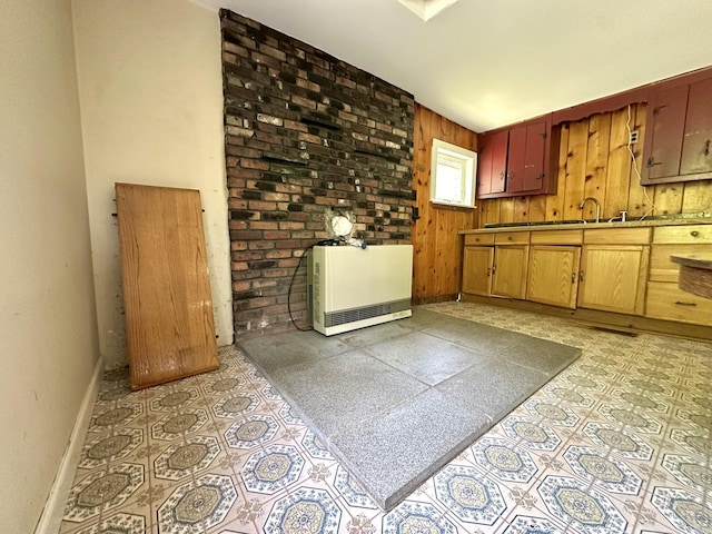 13 Mountain Rd, Newfield, ME 04095 - kitchen featuring baseboards, heating unit, wooden walls, and light flooring