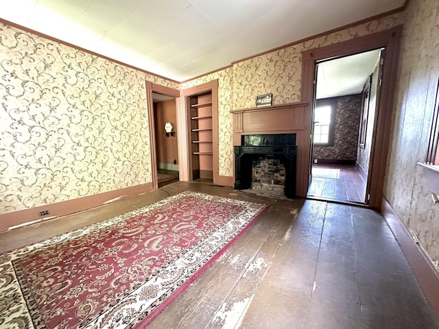 13 Mountain Rd, Newfield, ME 04095 - unfurnished living room with wallpapered walls, a fireplace with flush hearth, crown molding, baseboards, and hardwood / wood-style floors