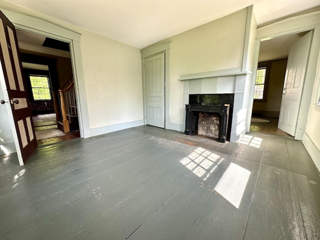 13 Mountain Rd, Newfield, ME 04095 - unfurnished living room with a tiled fireplace, plenty of natural light, wood finished floors, and stairway