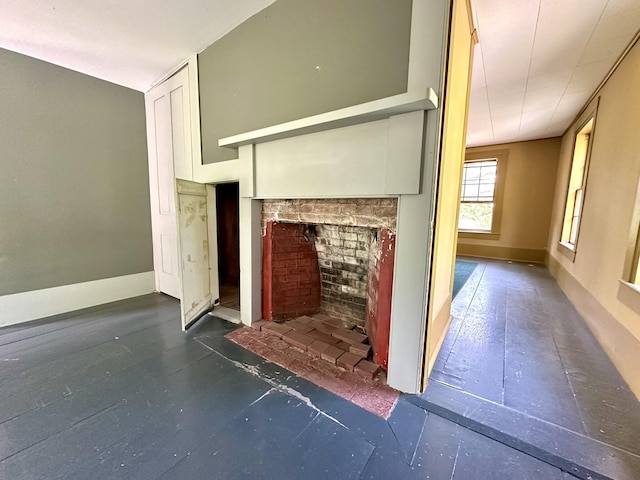 13 Mountain Rd, Newfield, ME 04095 - unfurnished living room featuring a brick fireplace and baseboards