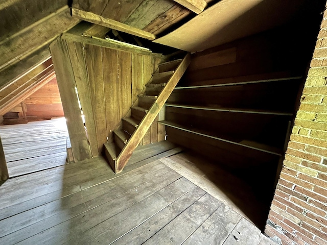 13 Mountain Rd, Newfield, ME 04095 - staircase with lofted ceiling, wood walls, and hardwood / wood-style flooring