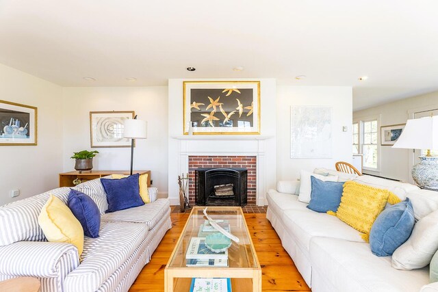250 Davis Point Rd, Cushing, ME 04563 - living room featuring light wood-style floors, a brick fireplace, and recessed lighting