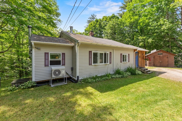 43 Vista Dr, Windham, ME 04062 - view of front of house featuring a chimney, a front lawn, a shed, and a shingled roof