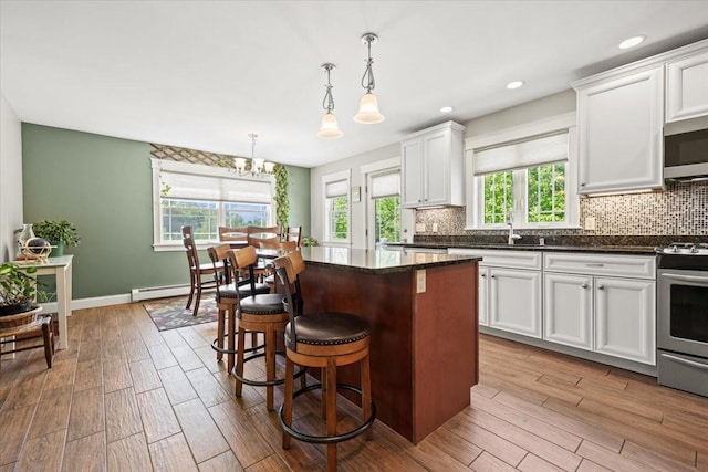 64 New Settlement Rd, Hiram, ME 04041 - kitchen with stainless steel appliances, plenty of natural light, wood finished floors, and recessed lighting