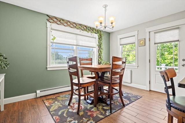 64 New Settlement Rd, Hiram, ME 04041 - dining room featuring baseboard heating, a chandelier, and wood finished floors