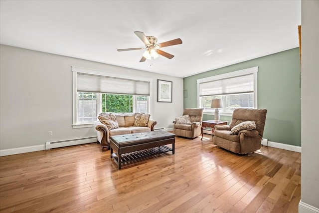 64 New Settlement Rd, Hiram, ME 04041 - living room with a baseboard radiator, ceiling fan, and light wood-style floors