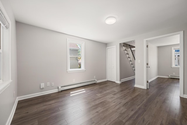41 Parker St, Bangor, ME 04401 - unfurnished room featuring baseboard heating, stairs, dark wood finished floors, and baseboards