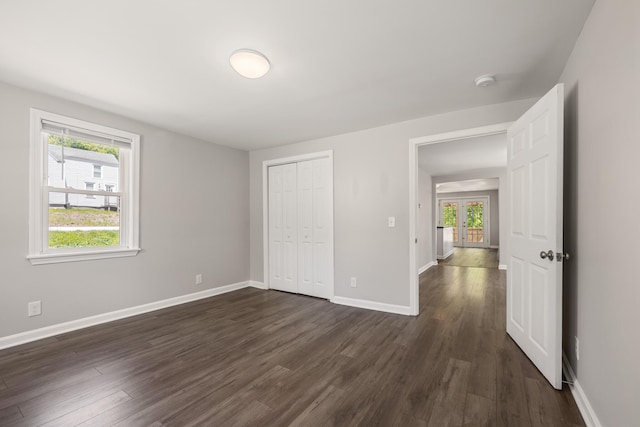 41 Parker St, Bangor, ME 04401 - unfurnished bedroom featuring dark wood-style flooring, baseboards, french doors, and a closet