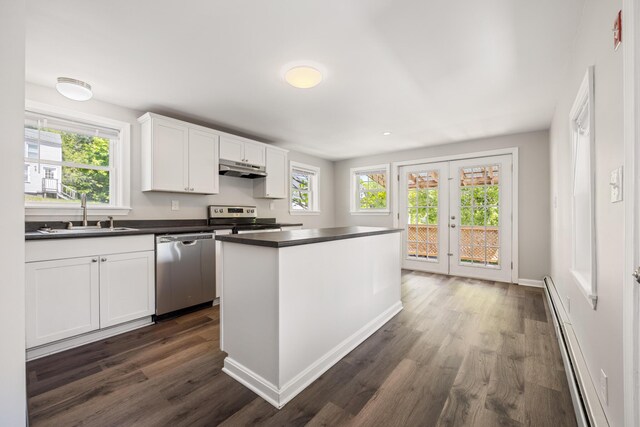 41 Parker St, Bangor, ME 04401 - kitchen with stainless steel appliances, a sink, baseboard heating, dark wood finished floors, and dark countertops