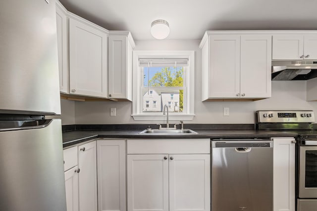 41 Parker St, Bangor, ME 04401 - kitchen with stainless steel appliances, under cabinet range hood, a sink, and dark countertops