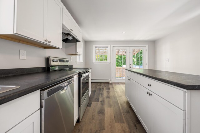 41 Parker St, Bangor, ME 04401 - kitchen featuring stainless steel appliances, under cabinet range hood, dark countertops, white cabinetry, and dark wood-style flooring