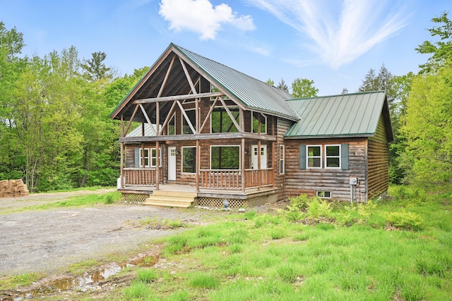 545 Back Rd, Skowhegan, ME 04976 - view of front of property featuring metal roof, log siding, and a porch