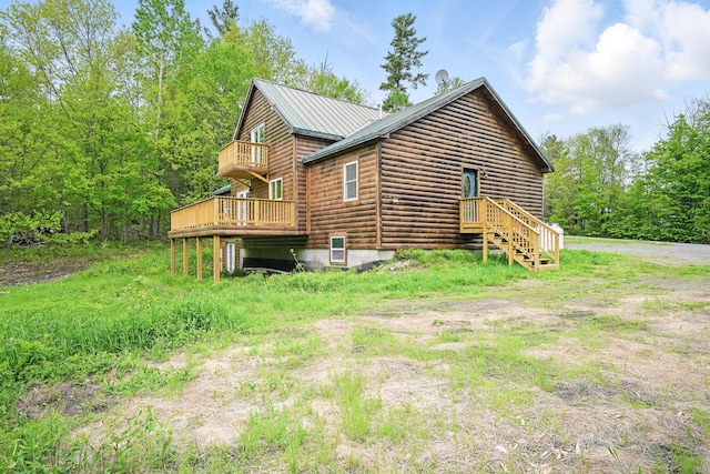 545 Back Rd, Skowhegan, ME 04976 - view of side of property with log veneer siding, metal roof, and a wooden deck