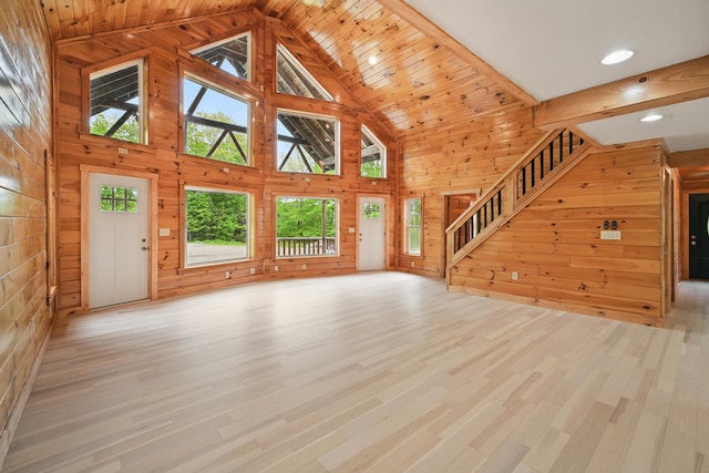 545 Back Rd, Skowhegan, ME 04976 - unfurnished living room featuring wooden walls, high vaulted ceiling, light wood-style flooring, stairs, and recessed lighting