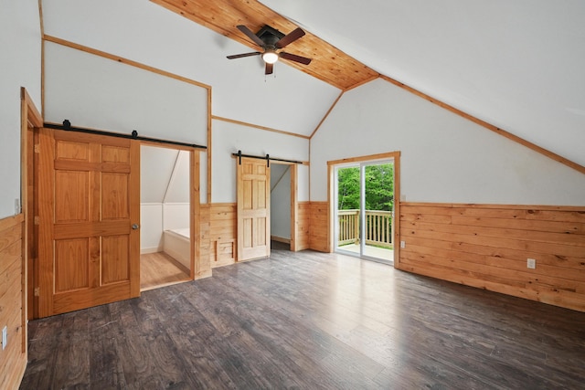 545 Back Rd, Skowhegan, ME 04976 - unfurnished living room with a barn door, wood finished floors, ceiling fan, wainscoting, and lofted ceiling