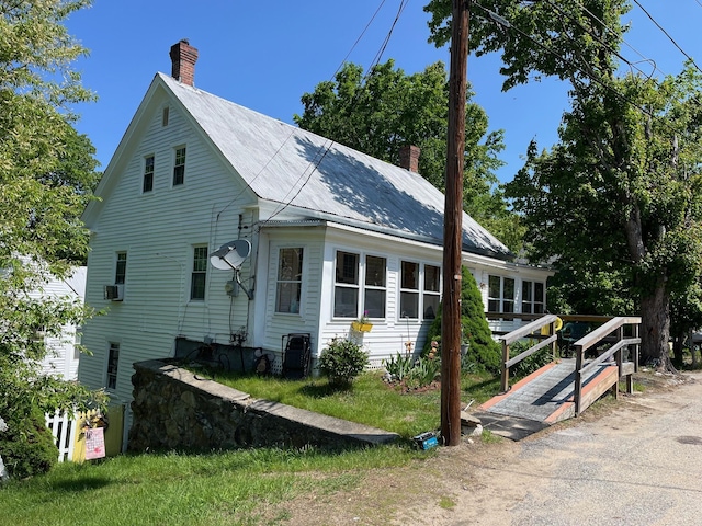 96 French St, Acton, ME 04001 - view of home's exterior featuring a chimney and metal roof