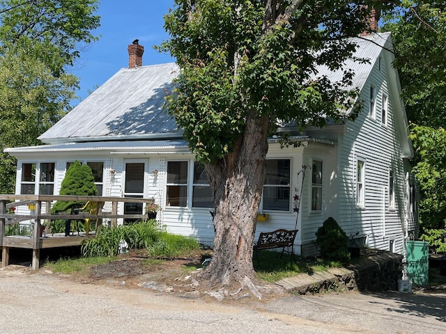 96 French St, Acton, ME 04001 - view of front facade featuring metal roof, a chimney, and a deck