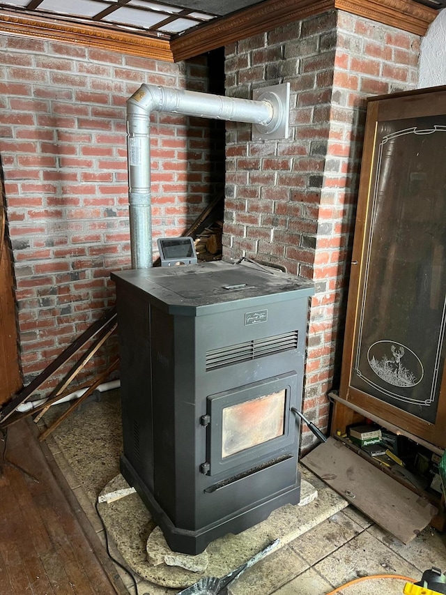 96 French St, Acton, ME 04001 - detailed view of a wood stove, brick wall, and wood finished floors